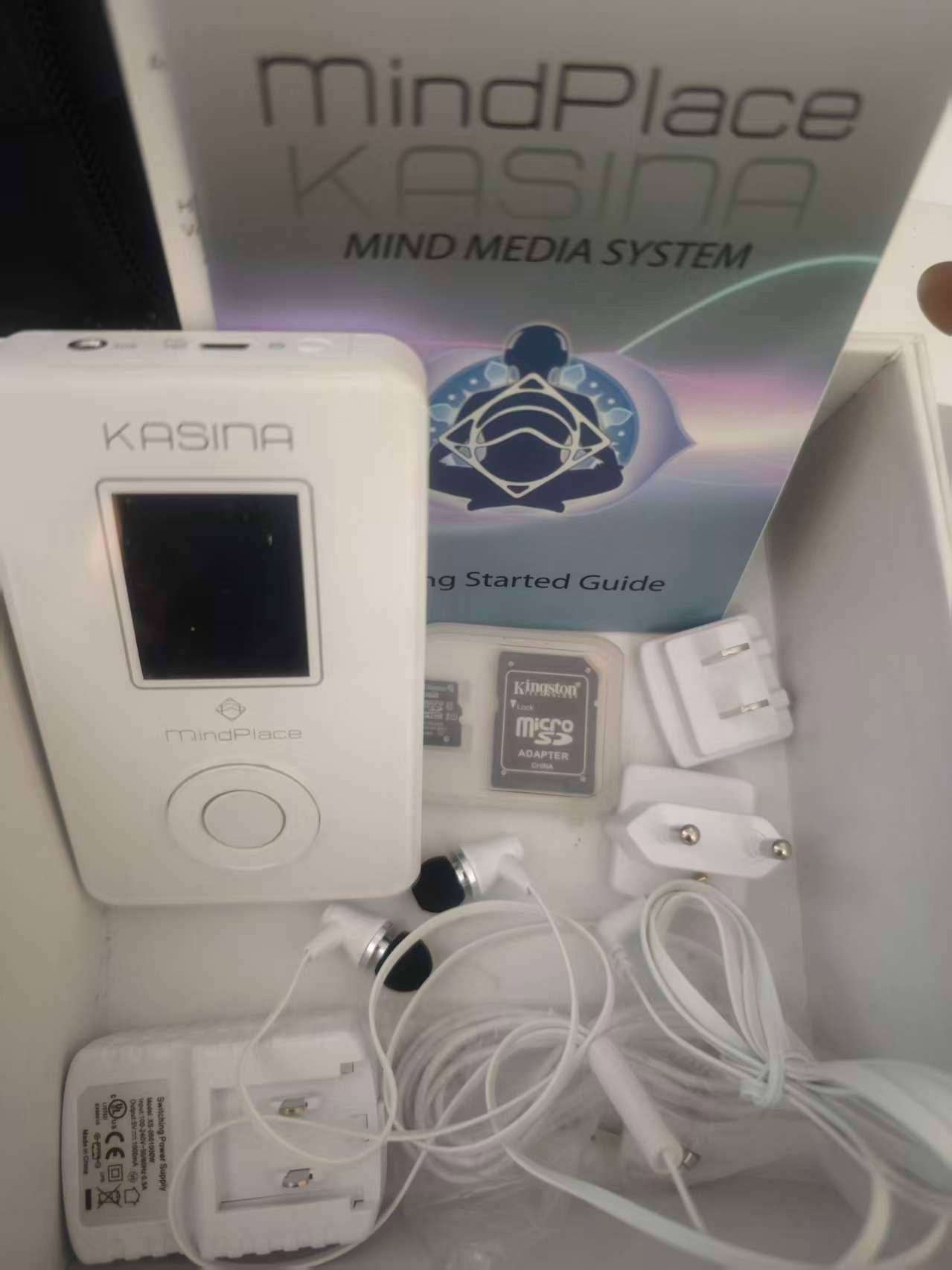 MindPlace Kasina device displayed with retail box, power adapter and bundled accessories.